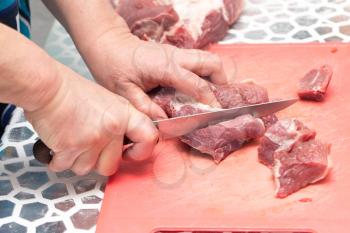 cutting meat with a knife