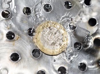 coins in a spray of water