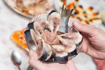 cut fish in hand plate