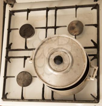 aluminum pan on old dirty gas stove