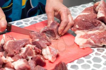 cutting meat with a knife