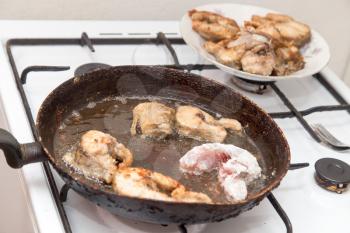 fish is fried in a pan in butter