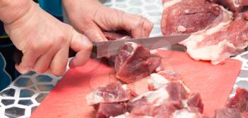 cutting meat with a knife