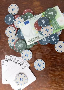 Casino chips and cards, and a hundred euros on the table
