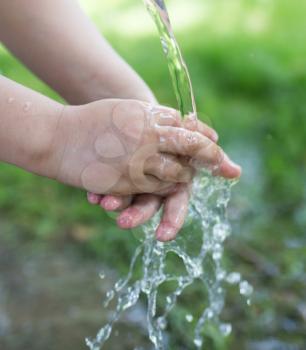 hand in tap water in nature