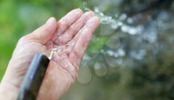 hand in tap water in nature