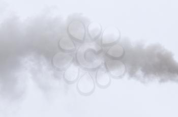 Smoke from a pipe on a cloudy sky