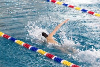 boy goes in for sports in the pool