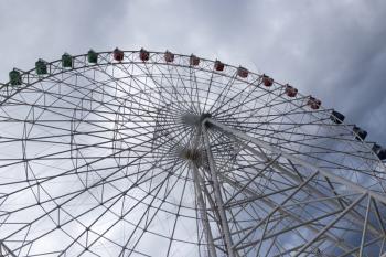 Ferris wheel on the background of clouds