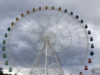 Ferris wheel on the background of clouds