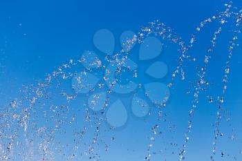 water splashing from the fountain in the background of blue sky