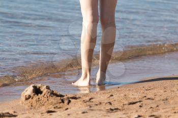 female legs on the beach