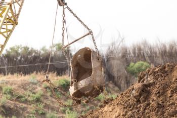 excavator digging a big bucket
