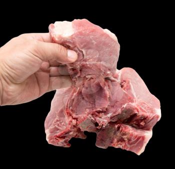 pork meat in hand on a black background