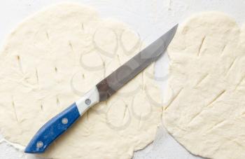 cutting the dough with a knife