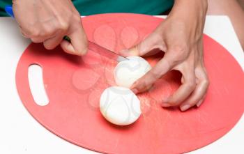 woman cuts onion knife