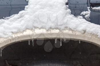 snow and icicles on cars in winter