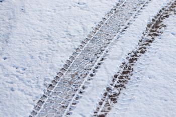 trace of wheel cars in the winter morning