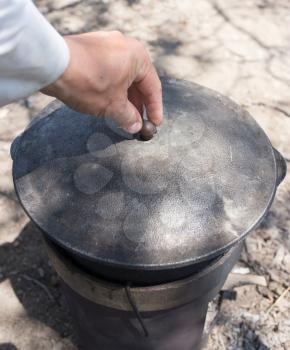 cooking in a cauldron on the nature