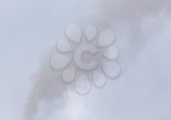 Smoke from a pipe on a cloudy sky