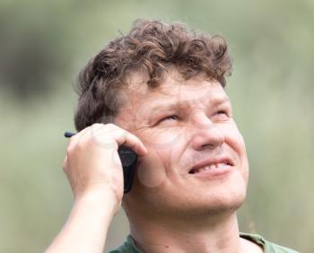 a man with a walkie-talkie outdoors