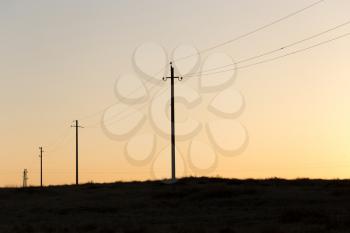 Electric poles at sunset