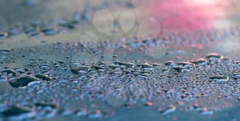 drops of water on a dark car