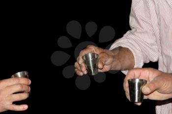 three wine glasses in hands on a black background