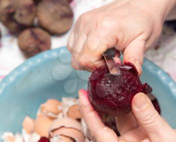 woman cleans the red beets