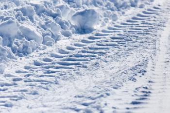 trace of the car in the snow as a background