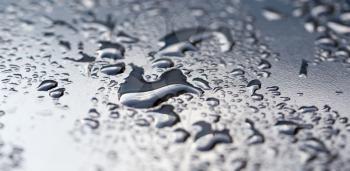 drops of water on a dark car .