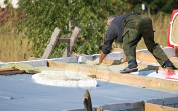 Workers cut the roof in the house .