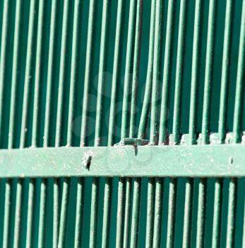 Metallic fence painted with green paint as a background .