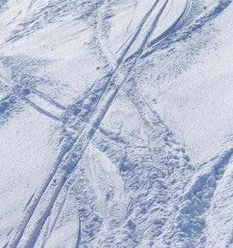 Traces of skis on snow as background .