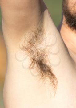 Hair under the armpit of a man .