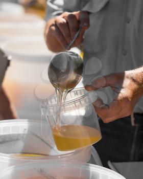 the beekeeper sells honey in the market .