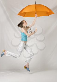 Beauty girl jump with orange umbrella