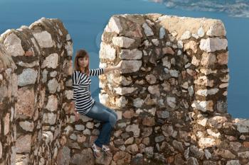 Royalty Free Photo of a Girl on an Old Fortress