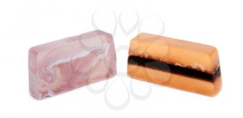 Two pieces of fruit soap on white background