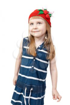 pretty little girl in beautiful striped blue dress and a red cap with a pattern of strawberries isolated on white background