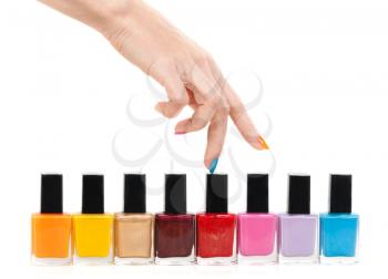 Female hand fingers are the colored paints polish isolate on a white background