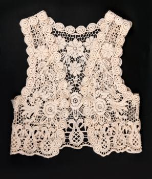 knitted vest of lace on a black background
