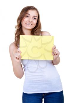 young girl shows empty sheet of a yellow paper. Isolation on the white