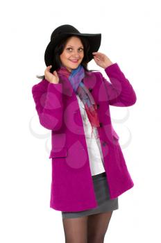Cheerful girl in a coat and hat. Isolated on white background