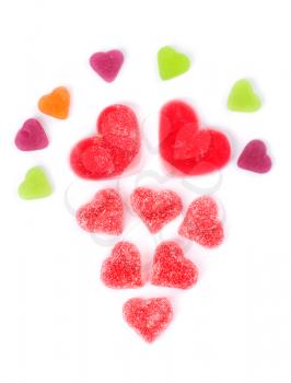 chewy colored candies in heart shape on white background