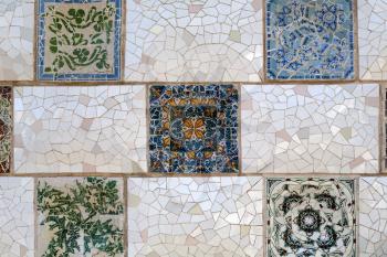 Detail of a mosaic on the wall. Close-up of the ceramics in Park Guell Barcelona created by Gaudi