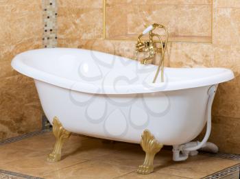 Interior of luxury bathroom with gold fittings