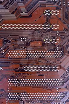 A close up shot of a computer brown motherboard.