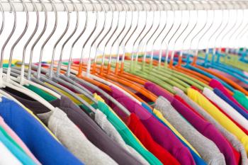 Collection of colored shirts on steel hangers. Isolate. Shallow depth of field.