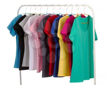 Colored shirts on hangers in a row. Isolate on white background.
